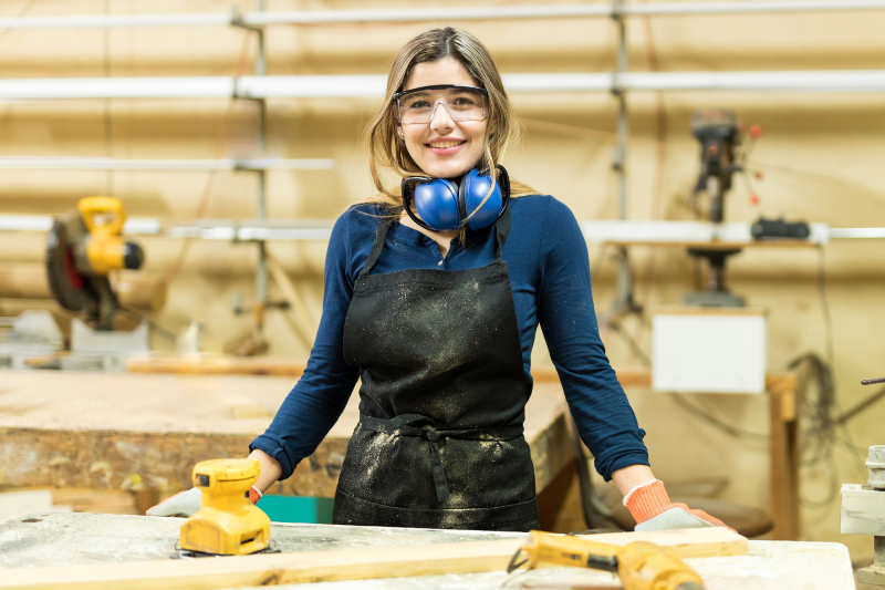 Teen smiling in wood workshop