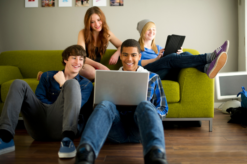 Teenagers looking at laptops