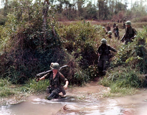 American troops wading across a flooded stream in 1968, during the Vietnam War 