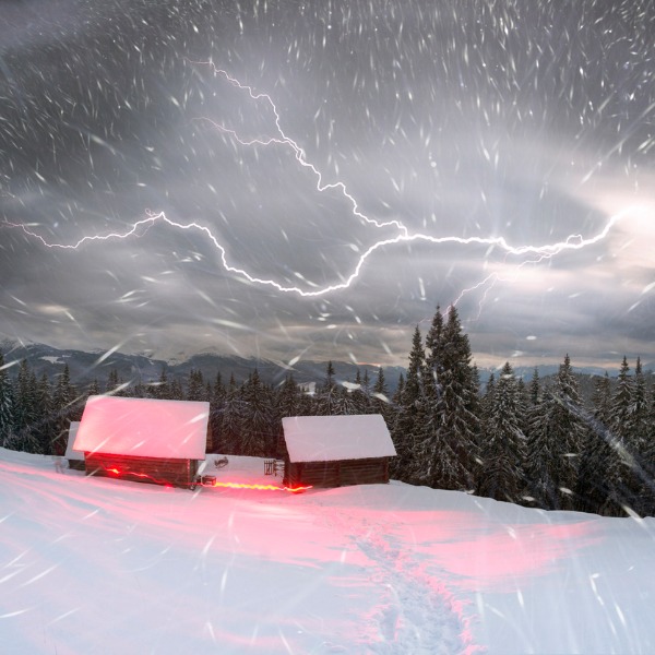 Thundersnow near a cabin on a hillside