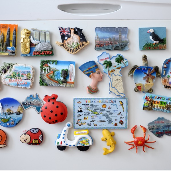 Assortment of souvenir magnets on the fridge