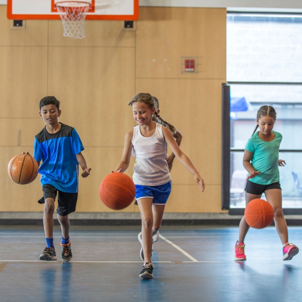 Children bouncing basketballs