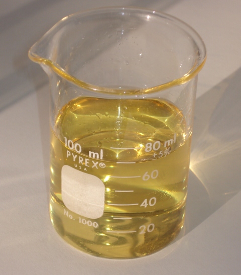 Shown is a colour photograph of a 100 ml beaker of biodiesel.
