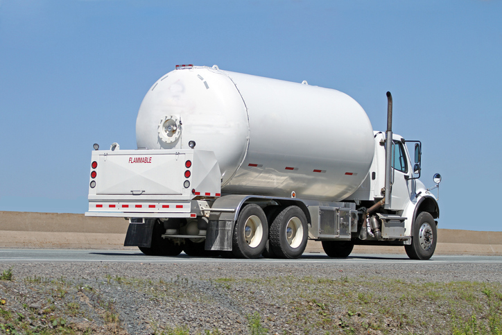 Shown is a colour photograph of a truck carrying propane.