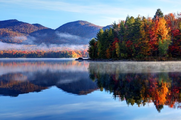Misty autumn lake and hillside