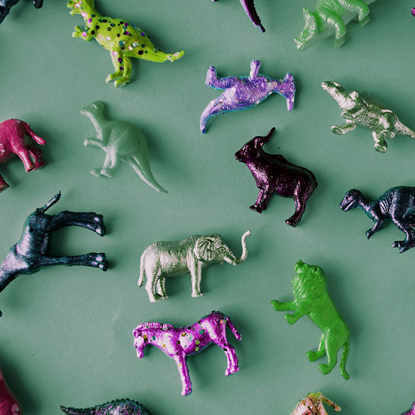 Collection of toy animals including dinosaurs