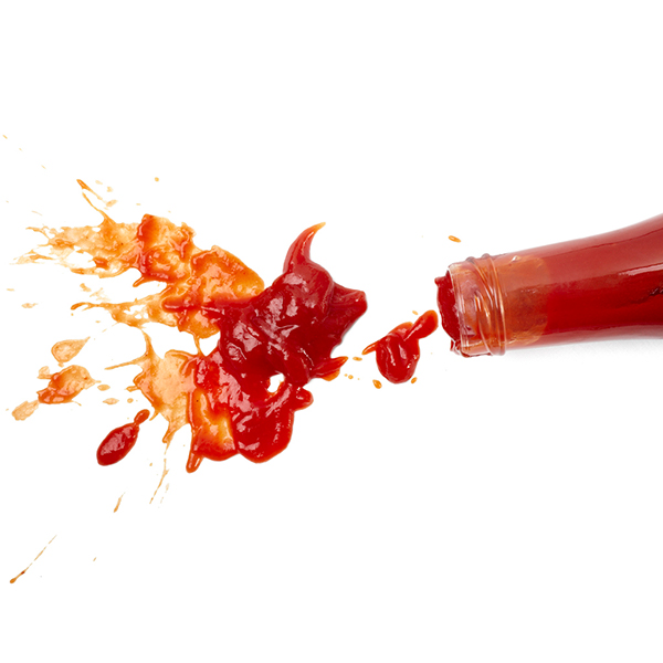 Ketchup bottle and ketchup spill