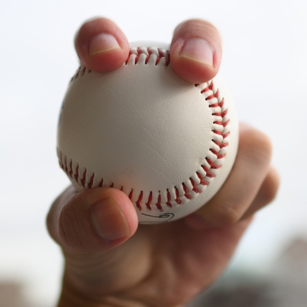 Hand holding a baseball