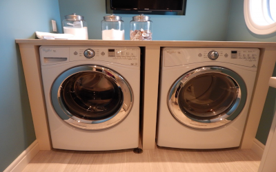 Washer and dryer with storage jars on top. 