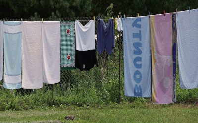 Clothes hanging out to dry with a fence in the background.