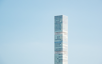 Tall corporate tower against a blue sky