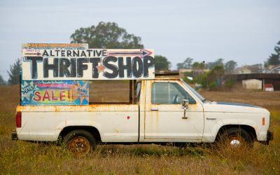 Sign to an "Alternative thrift shop" mounted on a truck