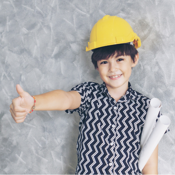 Child with hard hat with thumbs up gesture