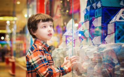 Child looking at goods in a store window
