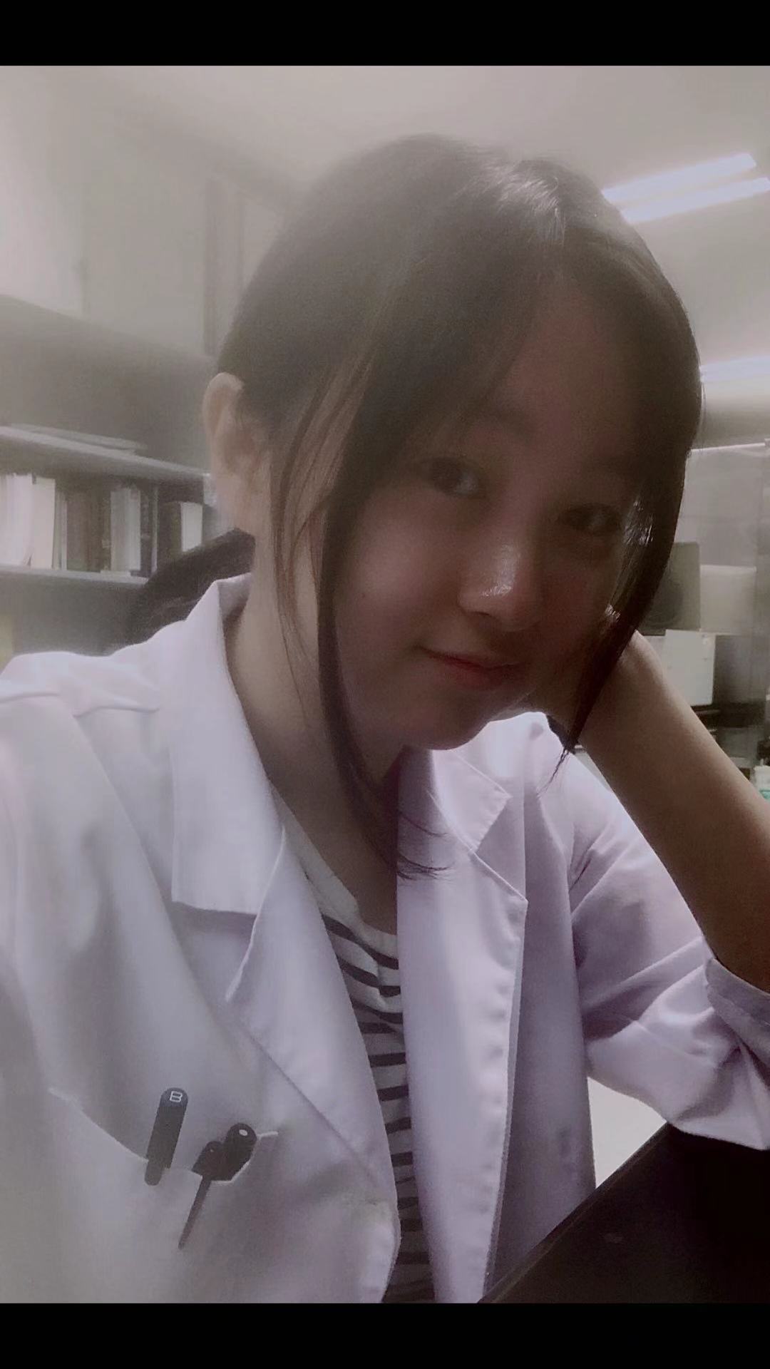 Yetong Dong headshot wearing lab coat
