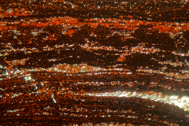 Shown is a colour photograph of the magnified texture of iron ore.