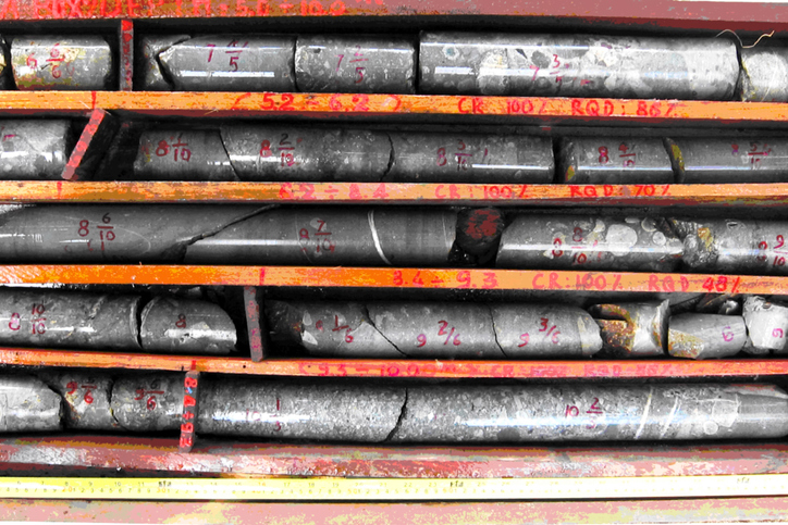 Shown is a wooden crate filled with cylinders of grey rock.
