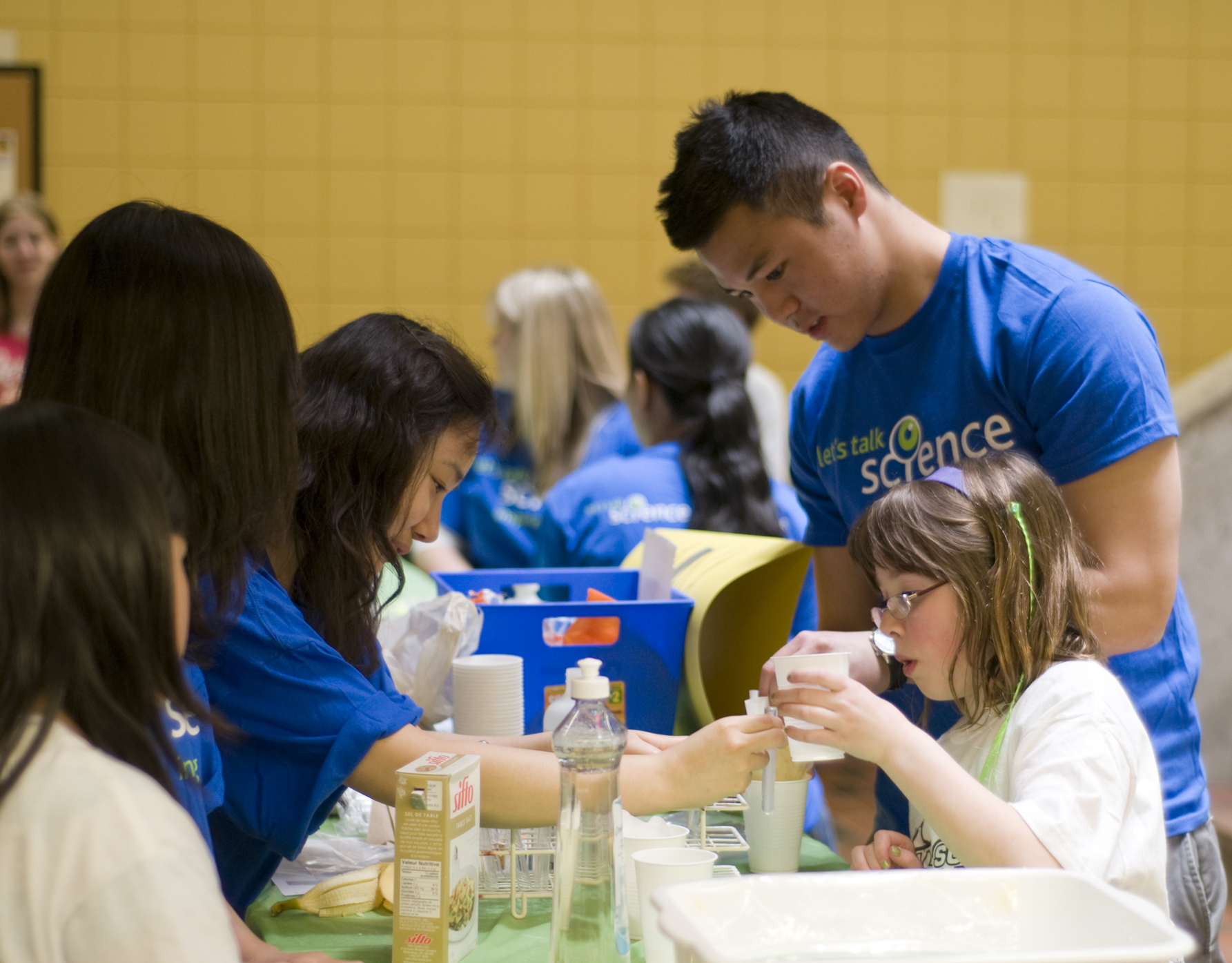 Volunteers with children at Let's Talk Science event