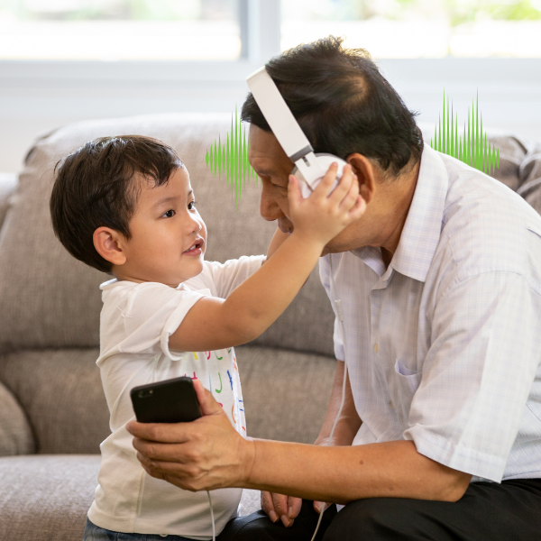Child playing with adult with headphones on 