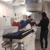 Person on medical table underneath imaging device