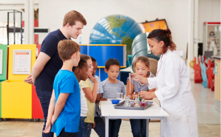 Teacher and students watching science experiment
