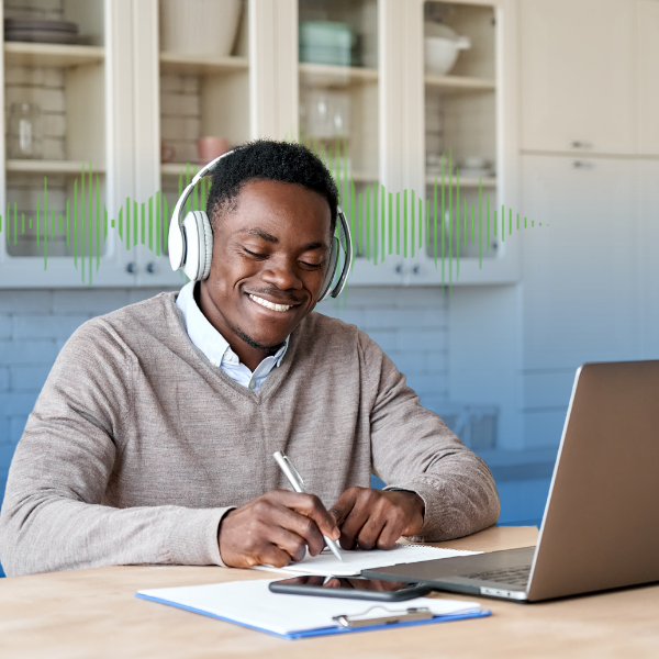 Man listening to headphones and using computer