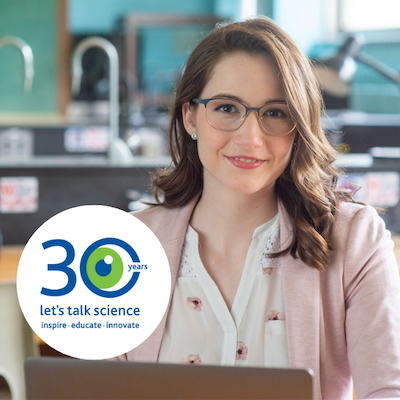 Melissa Valdez smiling at camera in a science lab with the Let's Talk Science 30th Logo