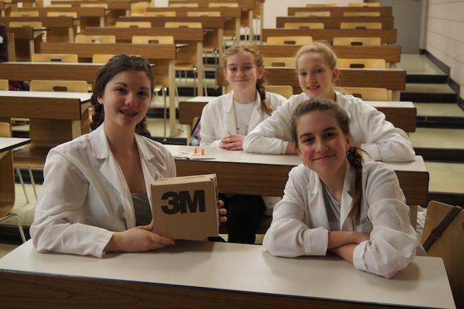 Veronica Mills with teammates at Let's Talk Science Challenge dressed in white lab coats