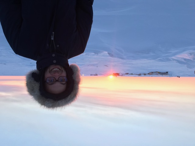 Ian in the arctic with sunset behind him