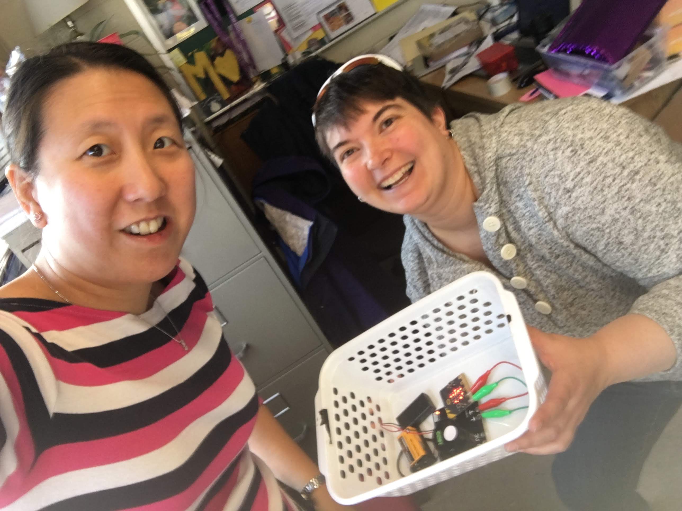 Winnie with co-worker Kendra showing their microbit creation