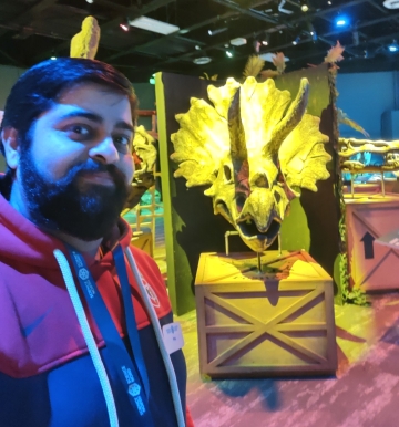 Anuj Sharma with sculpted dragon head in background