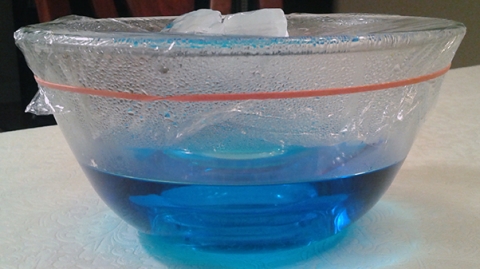 Water cycle model using plastic wrap and ice cubes over a bowl of warm water