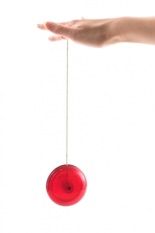 A yo-yo moves up and down 