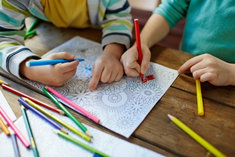 Young students using markers to colour mandala patterns