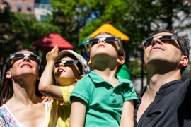 A family watches an eclipse 