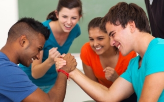 Teenage boys arm wrestling at school