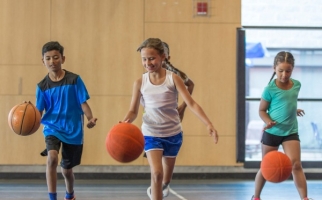 Children bouncing basketballs