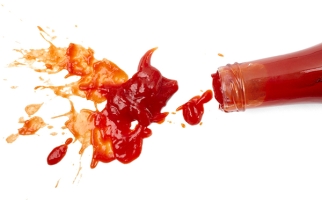 Ketchup bottle and ketchup spill