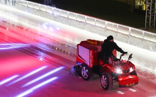 Ice technician on a zamboni at an outdoor skating rink