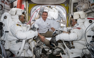 Astronaut David Saint-Jacques assists spacewalkers Nick Hague and Anne McClain