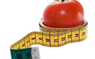 A measuring tape wrapped around a tomato