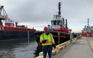 Daryl Lawes in front of one of Seaspan’s many tugboats supporting marine transportation.