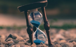 Hourglass filled with blue sand 