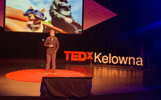 Andre Boysen presenting onstage at TEDx Kelowna