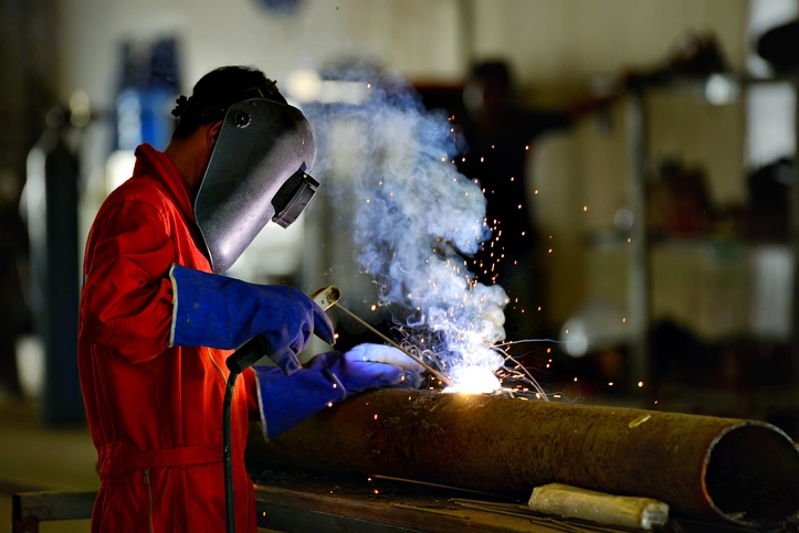Arc welder wearing protective equipment