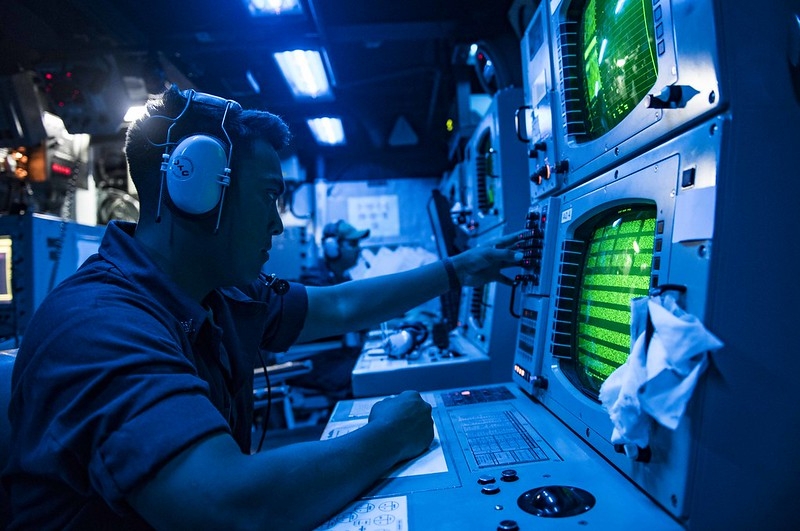 Sonar operator in the sonar room of a U.S. Navy vessel.