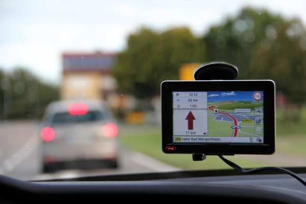 Shown is a colour photograph of a map on a small screen attached to a car windshield. 
