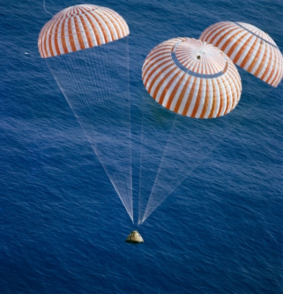 The Apollo 17 Command Module returns to Earth on December 19, 1972, suspended from three parachutes