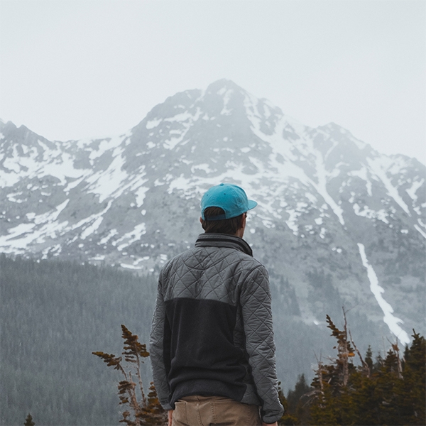Man looking out towards the mountains. 