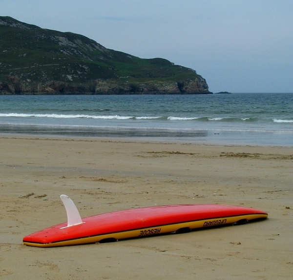Underside of a surfboard. The fin is the curved object pointing upwards 